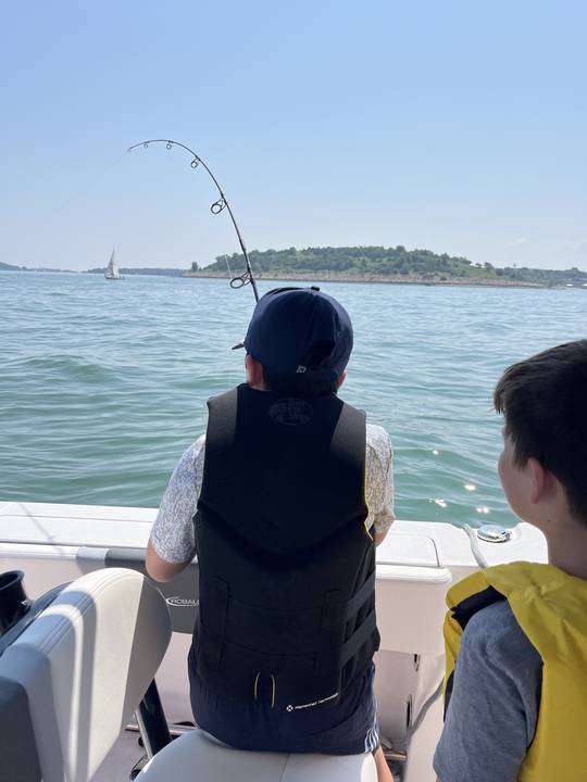 Two boys watching a bent rod with an island behind