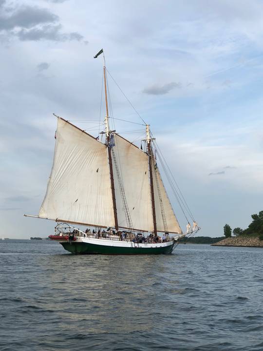 A green hulled schooner working past the islands