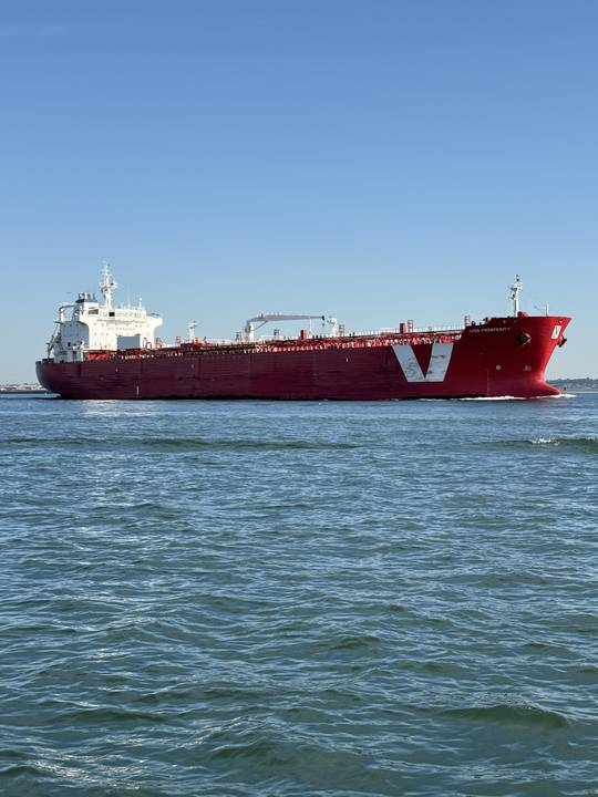 A tanker running the channel on a flat blue day